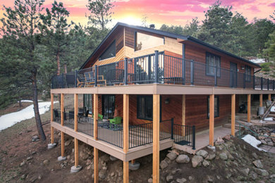 Example of a large classic backyard second story metal railing deck design in Denver with no cover