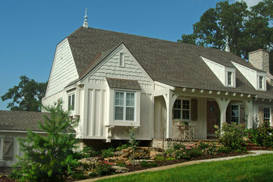 Small arts and crafts two-story wood exterior home photo in Other
