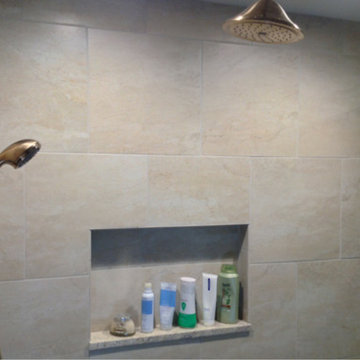 Rain head and adjustable shower head and recessed niche in a columbus shower rem
