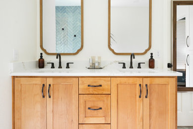 Mid-sized beach style master gray floor and double-sink freestanding bathtub photo in Dallas with shaker cabinets, light wood cabinets, quartz countertops, white countertops and a built-in vanity
