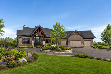 Large modern beige one-story stucco exterior home idea with a green roof and a black roof