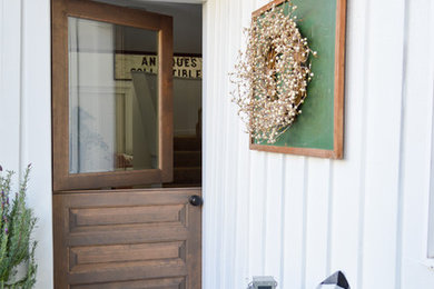 Cottage side porch photo in Seattle with a roof extension