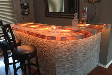 This is an example of a small modern home bar in Dallas with onyx worktops.