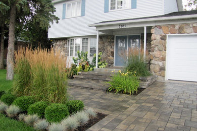 Traditional garden in Montreal with brick pavers.