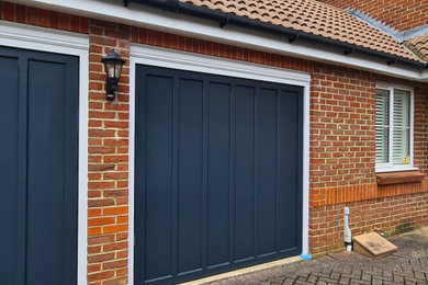 Inspiration for a large modern detached garage conversion in Surrey with three or more cars.