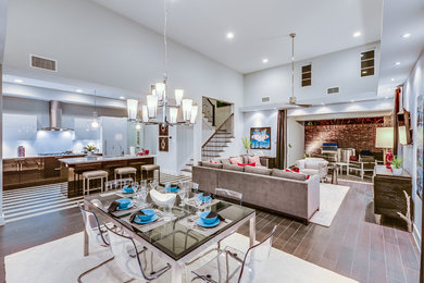 Great room - mid-sized contemporary dark wood floor great room idea in Houston with white walls and no fireplace