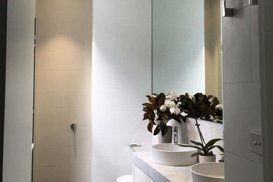 This is an example of a contemporary bathroom in Melbourne with ceramic tile.