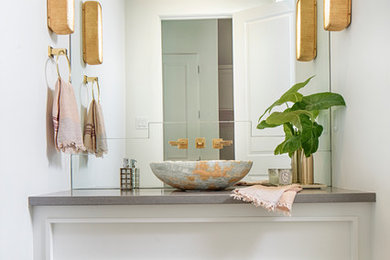 Powder room - large modern gray tile powder room idea in Denver with furniture-like cabinets, white cabinets, white walls, a vessel sink and marble countertops