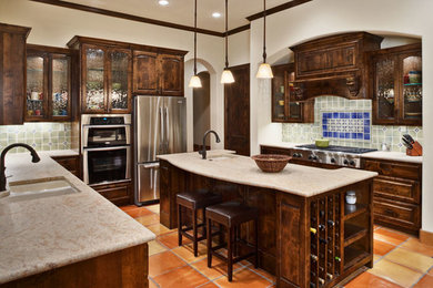 Eat-in kitchen - mediterranean u-shaped eat-in kitchen idea in Austin with an island