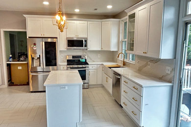 Example of a mid-sized minimalist galley porcelain tile and white floor open concept kitchen design in Baltimore with a farmhouse sink, shaker cabinets, white cabinets, quartz countertops, white backsplash, quartz backsplash, stainless steel appliances, an island and white countertops