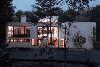 Large white three-story concrete flat roof photo in New York
