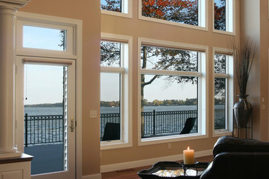 Example of a large classic formal and open concept medium tone wood floor and brown floor living room design in Charlotte with beige walls, no fireplace and no tv