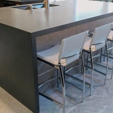 Metropolis Dark quartz waterfall island, stone base with metal trim
