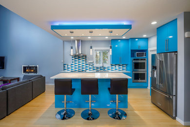Inspiration for a mid-sized contemporary light wood floor and beige floor open concept kitchen remodel in Vancouver with flat-panel cabinets, blue cabinets, blue backsplash, stainless steel appliances, an island and gray countertops