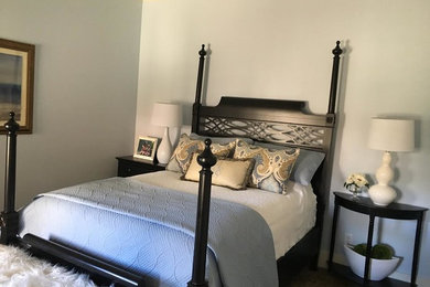 Example of a large transitional master medium tone wood floor and gray floor bedroom design in Other with blue walls and no fireplace