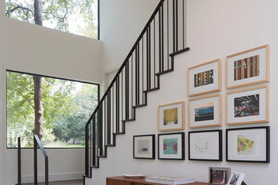 Small trendy concrete floor entryway photo in Austin with white walls