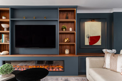 Inspiration for a medium sized contemporary games room in Other with light hardwood flooring, a standard fireplace, a built-in media unit, panelled walls and feature lighting.