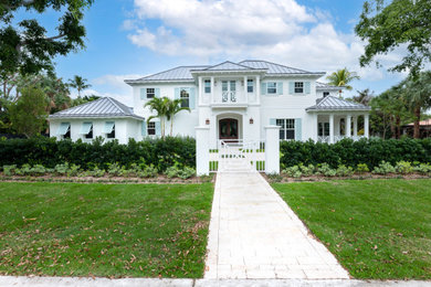 Trendy blue house exterior photo in Miami with a hip roof, a metal roof and a gray roof