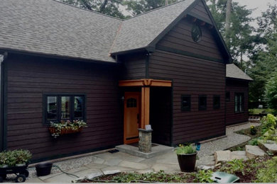 Example of a transitional brown two-story exterior home design in Boston with a shingle roof