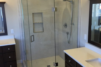 Bathroom - mid-sized transitional master beige tile and ceramic tile ceramic tile bathroom idea in Toronto with recessed-panel cabinets, dark wood cabinets, beige walls, an undermount sink and a one-piece toilet