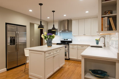 Design ideas for a small l-shaped eat-in kitchen in DC Metro with a farmhouse sink, recessed-panel cabinets, white cabinets, quartzite benchtops, stainless steel appliances, light hardwood floors, with island, beige floor and white benchtop.