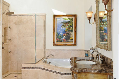 Inspiration for a mid-sized mediterranean master beige tile and stone tile marble floor bathroom remodel in San Francisco with furniture-like cabinets, medium tone wood cabinets, a two-piece toilet, beige walls, an undermount sink and marble countertops