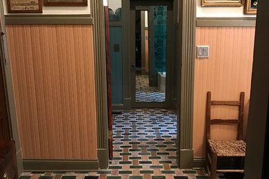 Example of a mid-sized classic master blue tile, green tile, multicolored tile and ceramic tile porcelain tile and multicolored floor bathroom design in Nashville with furniture-like cabinets, a wall-mount toilet, multicolored walls, marble countertops, a hinged shower door, gray cabinets and an undermount sink