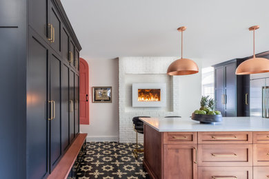 Inspiration for a mid-sized eclectic u-shaped cement tile floor, multicolored floor and wood ceiling enclosed kitchen remodel in Boston with a farmhouse sink, shaker cabinets, black cabinets, quartz countertops, white backsplash, ceramic backsplash, stainless steel appliances, an island and white countertops