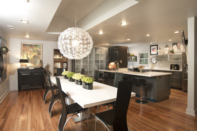This is an example of a large modern kitchen/dining combo in Other with white walls and medium hardwood floors.
