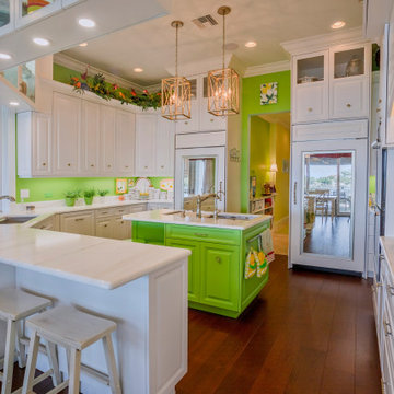Bright Coastal Kitchen With Bold Green Accents and Elegant White Cabinetry