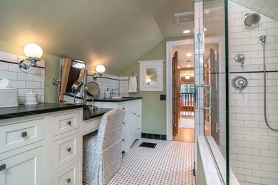 Walk-in shower - mid-sized farmhouse master white tile and subway tile porcelain tile and white floor walk-in shower idea in Other with recessed-panel cabinets, white cabinets, a one-piece toilet, green walls, an undermount sink, laminate countertops and a hinged shower door