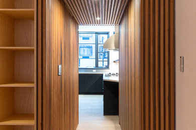 Example of a trendy light wood floor and beige floor kitchen design in New York with dark wood cabinets