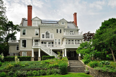 Inspiration for a large timeless backyard deck remodel in New York with an awning