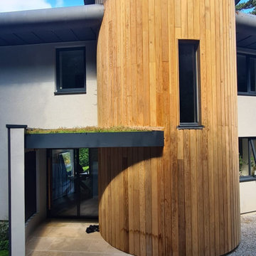 Home Entrance. Welcome home. We love the clad tower, home of the 3-flight stairc