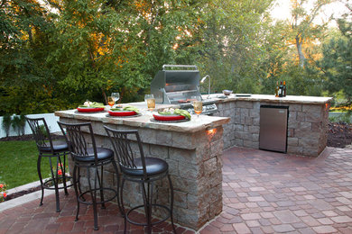 Elegant brick patio photo in Omaha with a bbq area