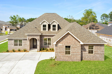 Large elegant two-story house exterior photo in Other with a shingle roof