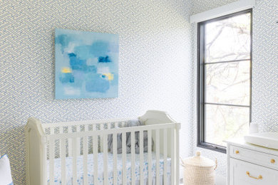 Inspiration for a mid-sized transitional boy blue floor and wallpaper nursery remodel in Austin