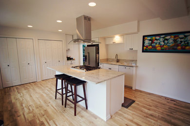 Photo of a mid-sized transitional single-wall eat-in kitchen in Seattle with an undermount sink, shaker cabinets, white cabinets, granite benchtops, white splashback, stainless steel appliances, linoleum floors, with island and stone slab splashback.