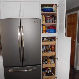 Mid-sized transitional kitchen pantry photos - Inspiration for a mid-sized transitional u-shaped slate floor kitchen pantry remodel in Portland Maine with an undermount sink, shaker cabinets, white cabinets, granite countertops, gray backsplash, subway tile backsplash, stainless steel appliances and an island