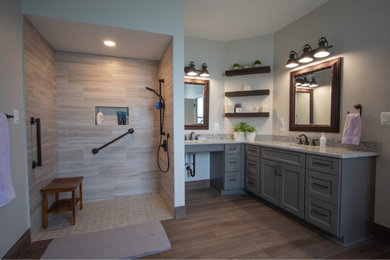 Large transitional master gray tile and porcelain tile porcelain tile, gray floor and double-sink bathroom photo in Baltimore with recessed-panel cabinets, gray cabinets, gray walls, an integrated sink, granite countertops, gray countertops and a built-in vanity