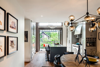 Inspiration for a large modern light wood floor kitchen/dining room combo remodel in Vancouver with white walls
