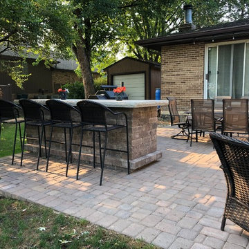 Outdoor Kitchen with Bar Height Table by Homer Glen, IL Outdoor Kitchen Builder.
