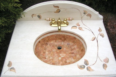 Limestone leaves inlaid into a marble vanity top