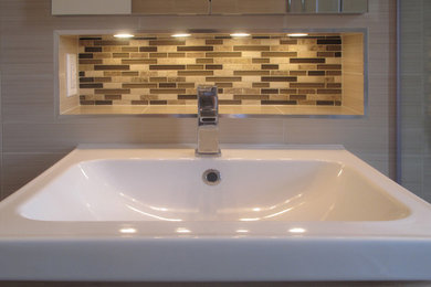 Example of a small minimalist master beige tile and ceramic tile ceramic tile doorless shower design in New York with a wall-mount sink, raised-panel cabinets, gray cabinets, wood countertops, a two-piece toilet and beige walls