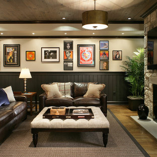 Design ideas for a large traditional fully buried basement in New York with beige walls, medium hardwood flooring, a standard fireplace and yellow floors.