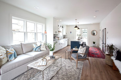 Example of a mid-sized transitional open concept vinyl floor and brown floor living room design in Other with a wall-mounted tv, white walls and no fireplace