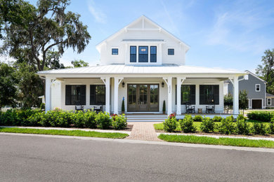 Huge farmhouse white two-story concrete fiberboard and clapboard house exterior idea in Jacksonville with a white roof, a hip roof and a metal roof