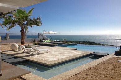 Inspiration for a mid-sized modern custom-shaped infinity hot tub remodel in Other