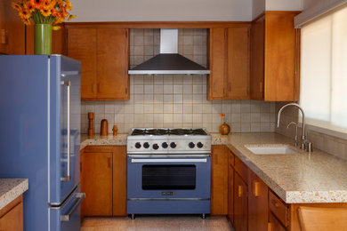 Small 1960s u-shaped terrazzo floor, white floor and exposed beam kitchen photo in Los Angeles with an undermount sink, terrazzo countertops, white backsplash, ceramic backsplash, colored appliances, no island and beige countertops