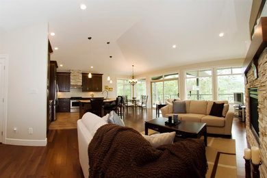 Living room - mid-sized transitional formal and open concept medium tone wood floor living room idea in Vancouver with beige walls, a standard fireplace and a stone fireplace